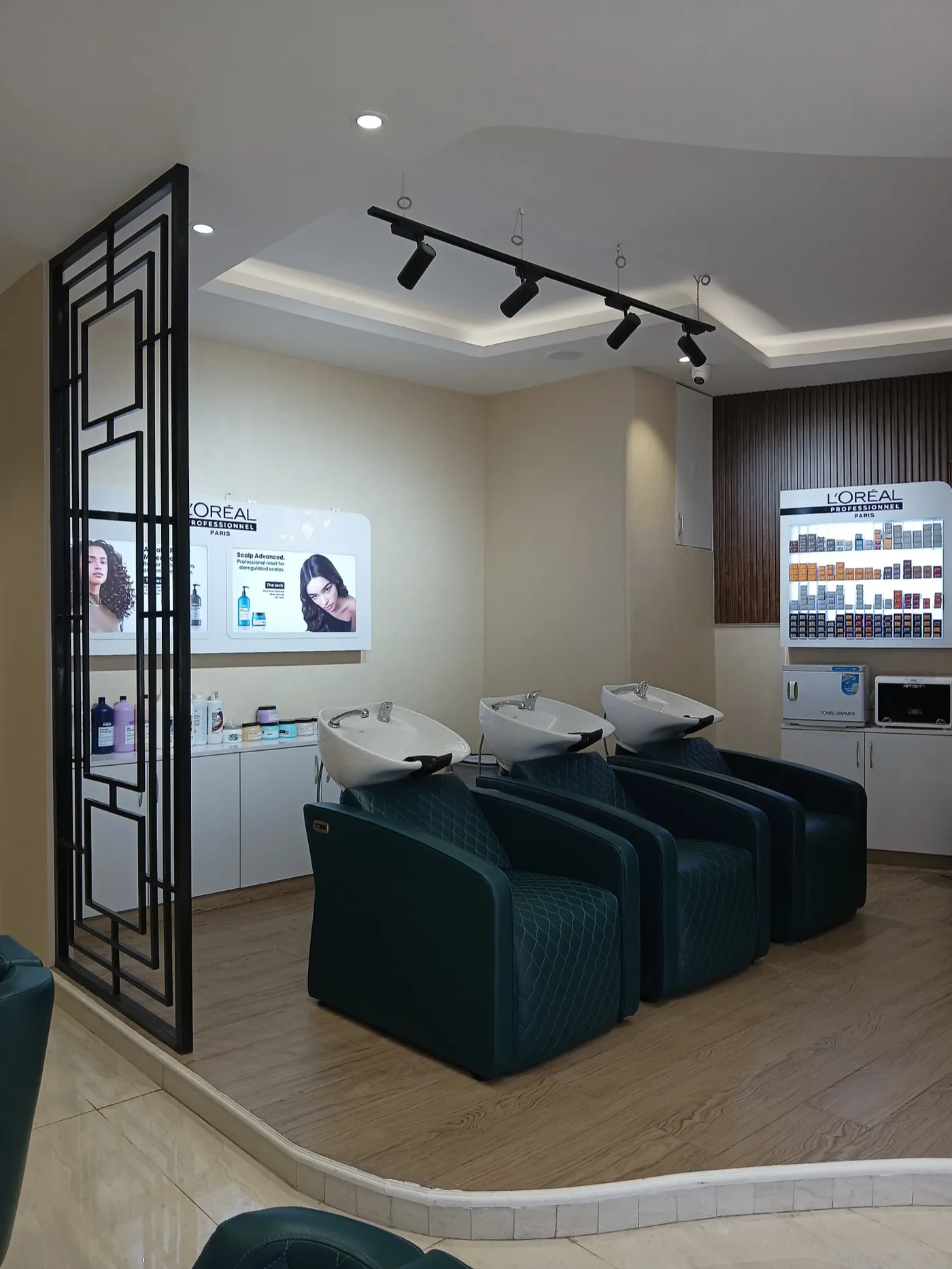 The hair wash area at MONSOON PRO SALON, with three basin chairs